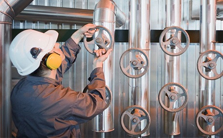 Engineer adjusting valve Engineer adjusting valve